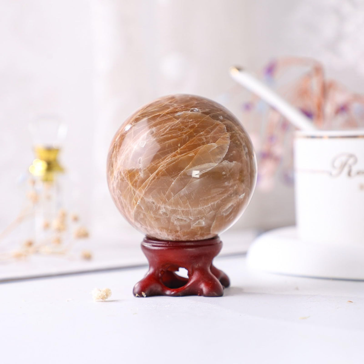 Nupuyai Natural Orange Moonstone Crystal Ball with Resin Stand, Healing Crystal Sphere for Home Decor 2.01"-2.36"(51mm-60mm)